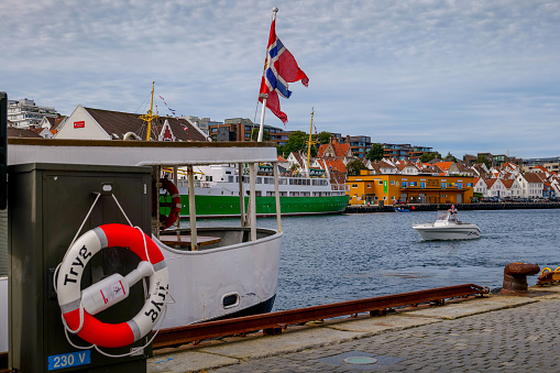 Stavanger, Norway, August 24 - A passenger ferry moored in the bay of Stavanger on the commercial and tourist port, while a small boat enters the port. Image in HD format.