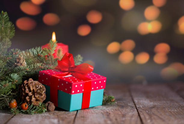 istock Gift box and fir branches with candles 1189311194