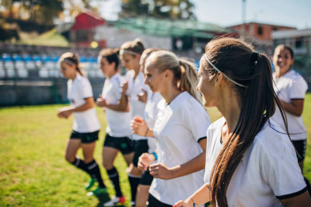 istock Ladies soccer team warming up together 1189313360