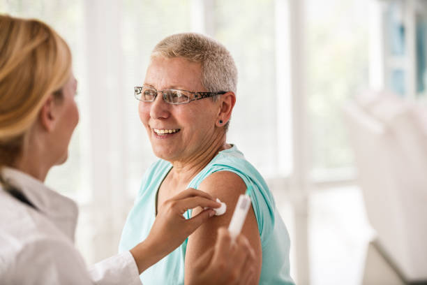 istock Doctor disinfecting patient's arm before vaccination 1189314773