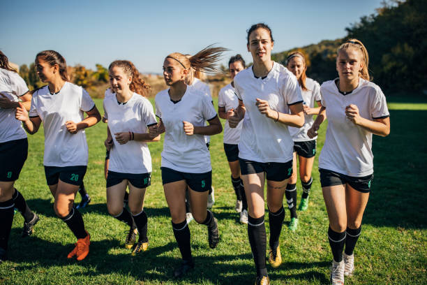 istock Women soccer team running together 1189314817