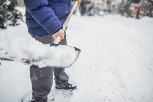 a man removes snow with a shovel - snow digging horizontal people imagens e fotografias de stock