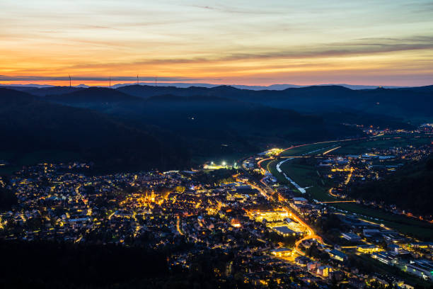 germany, black forest village skyline of haslach im kinzigtal houses, streets, cityscape illuminated by night, aerial view from above with red sky, a perfect nature landscape - forest black forest sky night imagens e fotografias de stock