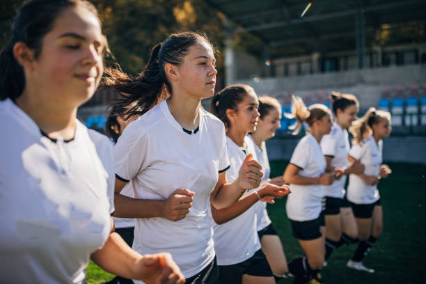 istock Ladies soccer team jogging together 1189319574