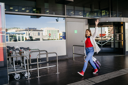 Cheerful young woman at the airport