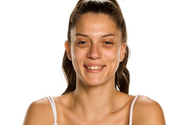 istock Young smiling woman without makeup on white background 1189321519