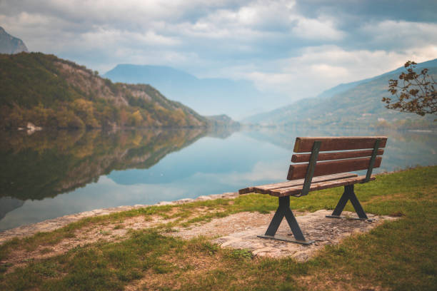 Lago di Cavedine beautiful lake. Wooden bench in focus. Italy. Arco.