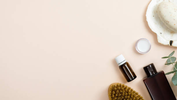 istock Zero waste accessories set for bathroom on beige background. Flat lay organic homemade cosmetic and tools for spa. Top view soap, essential oil in glass bottle, shampoo, brush. Eco friendly cosmetic 1189321778