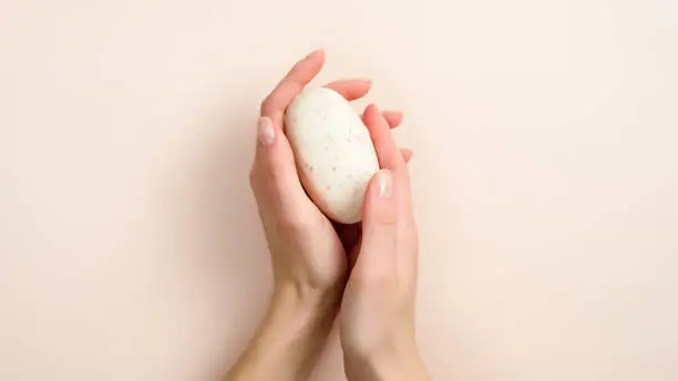 Photo of Female hands holding natural organic soap. Healthy lifestyle, beauty, skin care. Zero waste, plastic free bathroom and home concept.