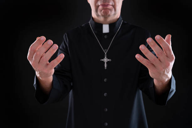 istock Priest blessing praying god bless open hands with cassock 1189322121