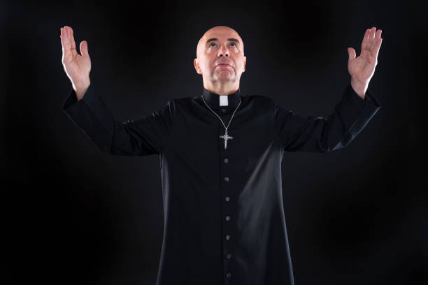 istock Priest blessing praying god open hands with cassock 1189322142