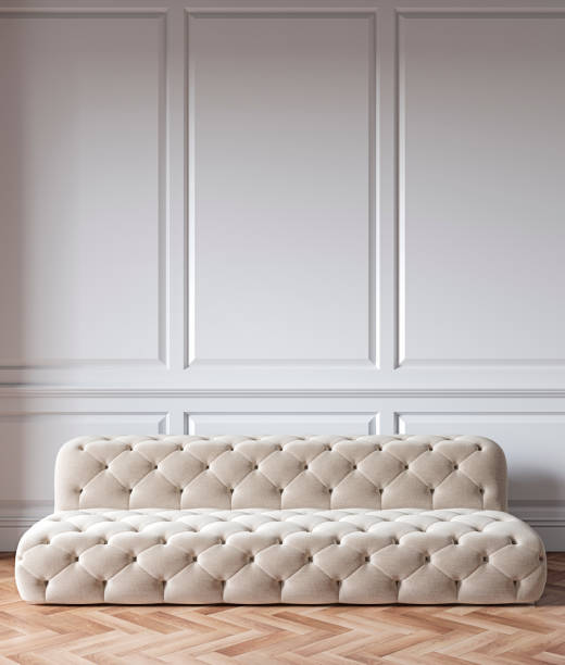 istock Classic white interior with capitone chester sofa, mouldings, wooden floor. 3d render illustration mock up. 1189322958