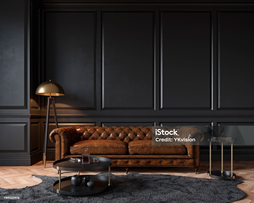 Modern classic black interior with capitone brown leather chester sofa, floor lamp, coffee table, carpet, wood floor, mouldings. 3d render interior mock up. Sofa Stock Photo