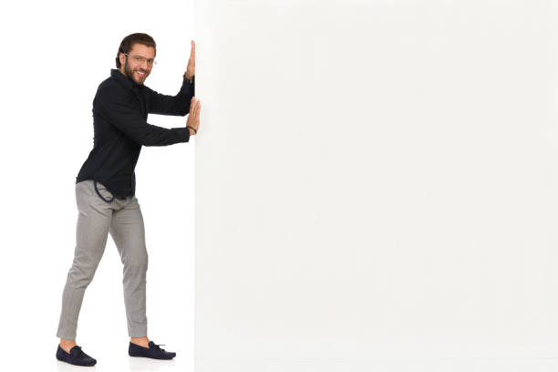 istock Handsome Smiling Man Is Pushing White Banner 1189323541