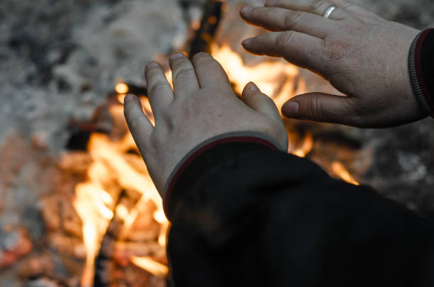 istock Woman warming his hands by the fire. 1189324232