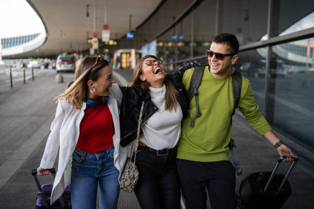 Cheerful friends at the airport Cheerful friends at the airport airport hug stock pictures, royalty-free photos & images