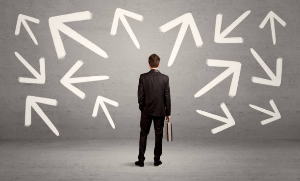 istock Confused salesman with arrows on wall 1189325242