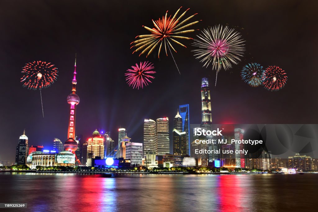Fireworks in Shanghai cityscape in China Beautiful fireworks in Shanghai cityscape with the city lights on the Huangpu River, China Firework Display Stock Photo