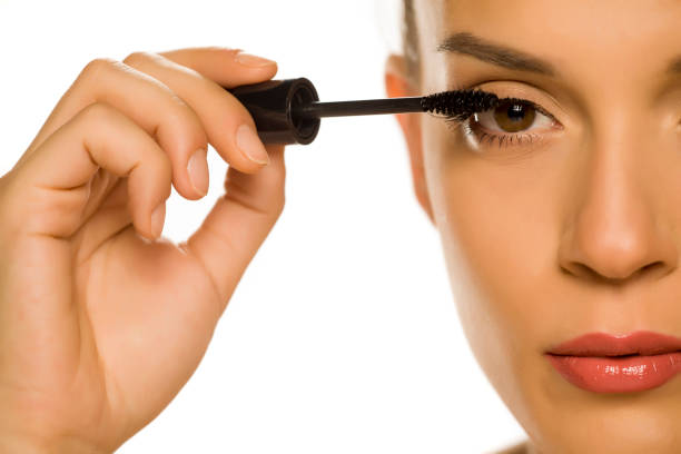 istock woman applying mascara on her eyelashes 1189325332