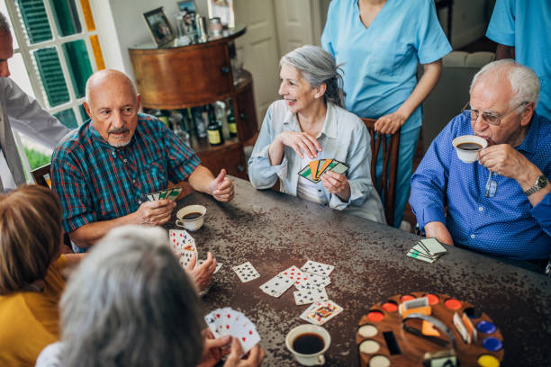 istock Senior friends playing cards in nursing home 1189325802
