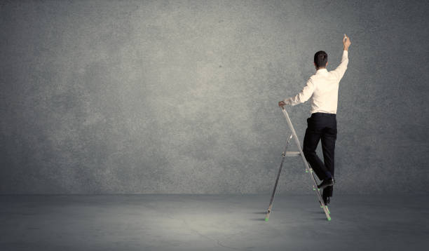 istock businessman drawing on grunge wall 1189328326