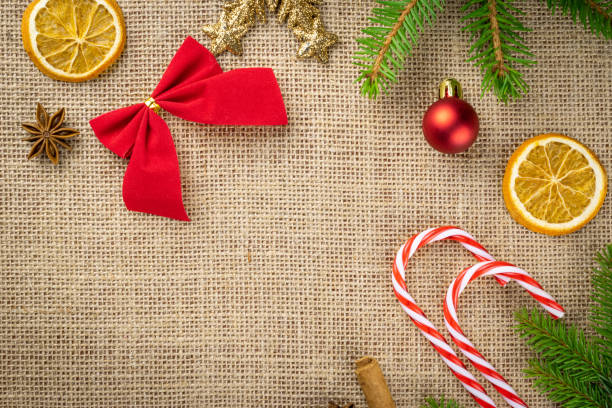 istock Happy New Years Day. Christmas celebration pattern. Gold Xmas decorations isolated on linen texture background.Banner mock up for display of product or design content 1189328552