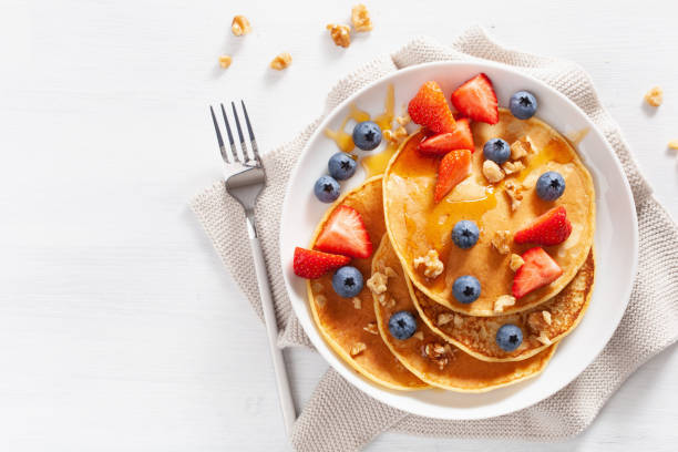 istock pancakes with blueberry strawberry honey and nuts for breakfast 1189329135