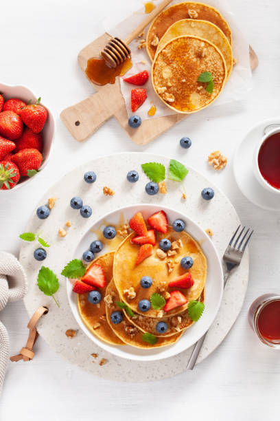 istock pancakes with blueberry strawberry honey and nuts for breakfast 1189329431