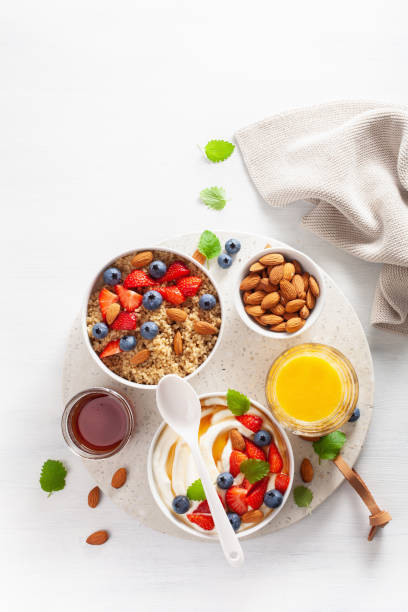 yogurt with strawberry blueberry honey almond and quinoa for breakfast - norway maple imagens e fotografias de stock