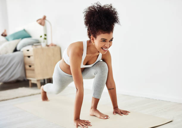 The time to start getting fit is right now Shot of a fit young woman doing yoga at home lunge stock pictures, royalty-free photos & images