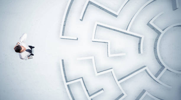 istock Business man looking at circular maze with nowhere to go 1189332937
