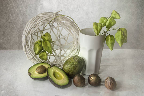 still life with sliced avocado on white background close up