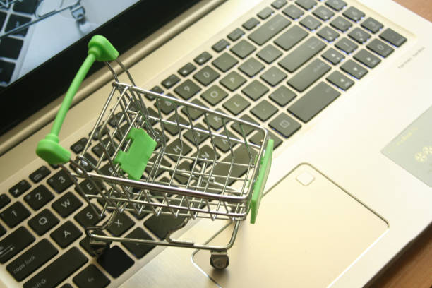 istock A mini dummy shopping trolley on a lapptop keyboard as a concept for online shopping, saving, business and making money as well as running a business. 1189333560