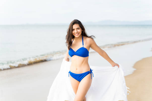 istock Young Woman Having Fun With Scarf On Beach 1189334239