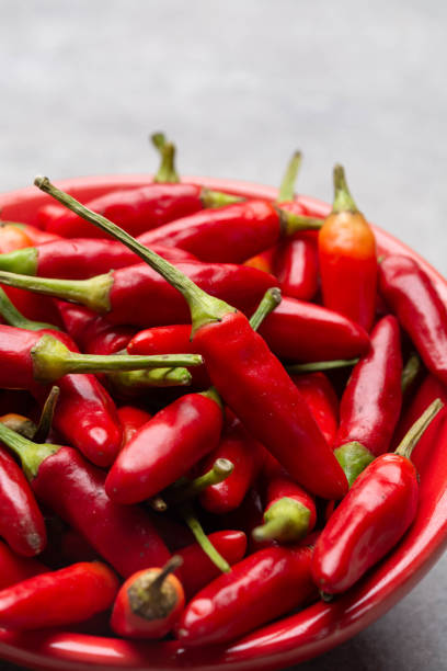 istock Fresh small red hot chili peppers on grey background 1189334755