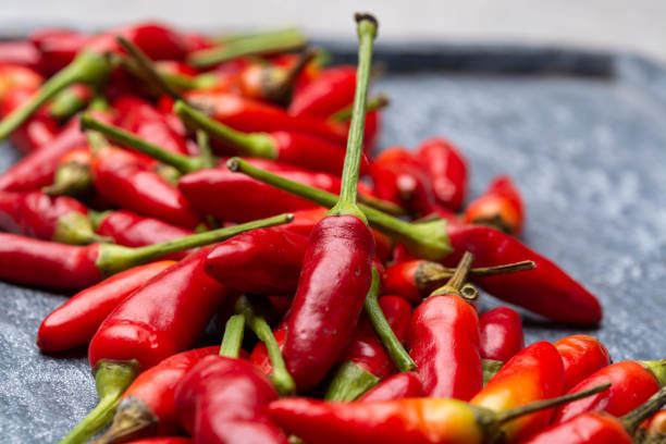 istock Fresh small red hot chili peppers on grey background 1189334789