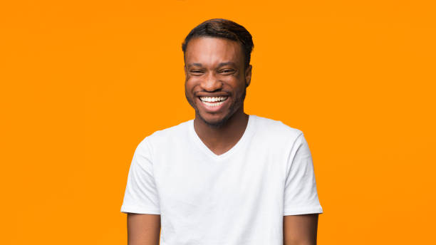 istock African American Guy Laughing Standing On Orange Background, Panorama 1189335760