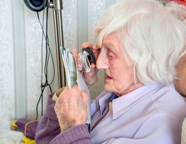 istock Visually impaired elderly woman with magnifyer 1189335841