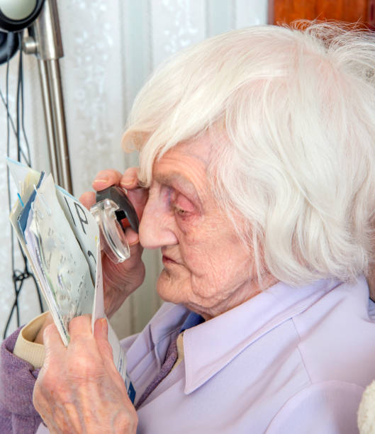 istock Visually impaired elderly woman with magnifyer 1189335842
