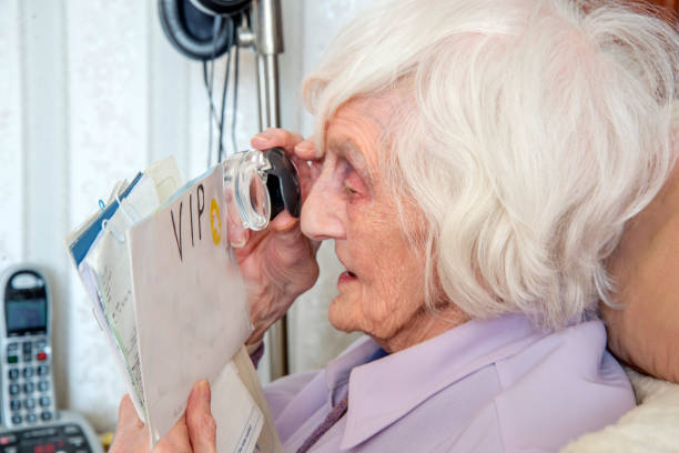 Visually impaired elderly woman with magnifying loupe.