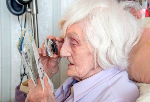 istock Visually impaired elderly woman with magnifyer 1189335848