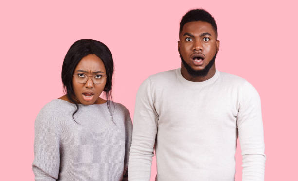 istock Amazed man and woman with open mouths 1189335852