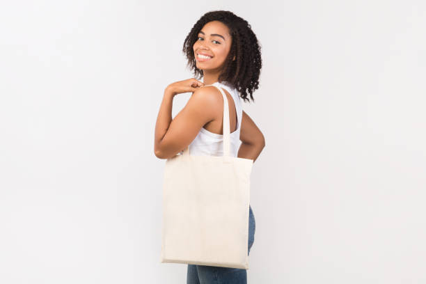 istock Black girl with blank eco sack on white background 1189336684