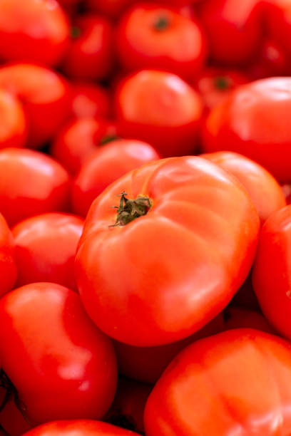 istock Red ripe tomatoes on farmets market close up 1189336830