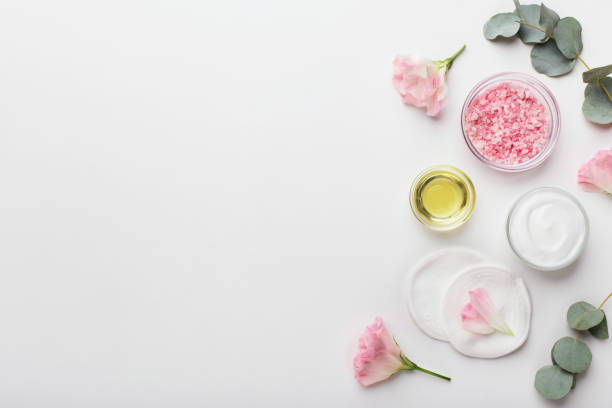 istock Sea salt with rose essential and face cream on white background 1189336832