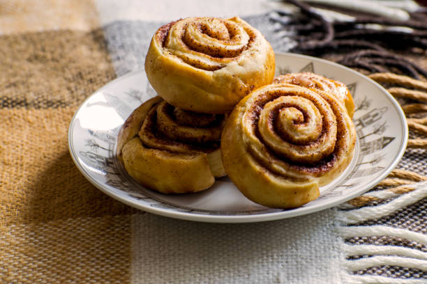 Cinnamon rolls buns with spices and cocoa. Kanelbulle - swedish sweet homemade dessert. Christmas baking pastry. Sweet cinnamon rolls buns with spices and cocoa. Christmas baking pastry. kanelbulle stock pictures, royalty-free photos & images