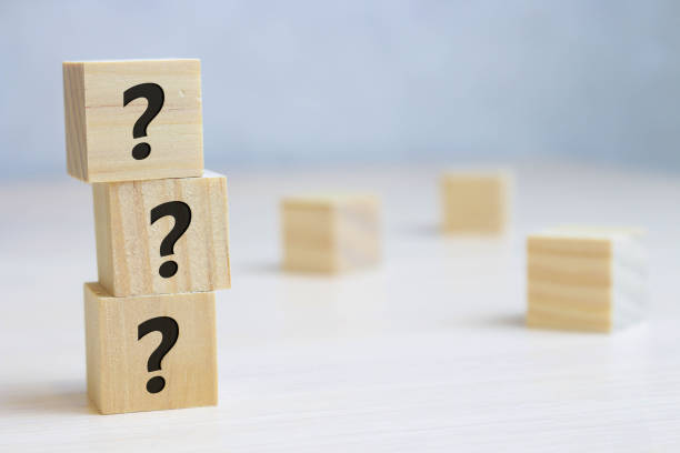 istock Wooden cube block shape with sign question mark symbol on wood table 1189341947