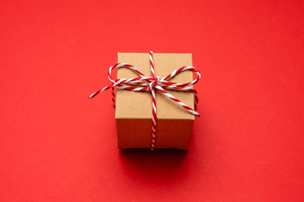 istock Christmas gift on a colored red background. New Year, holiday, give, pack. 1189341968
