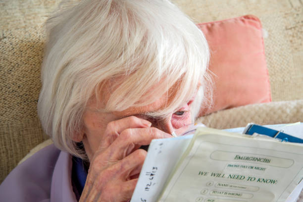 istock Visually impaired elderly woman with magnifyer 1189343851