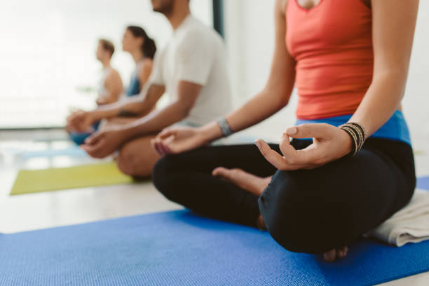 istock Students meditating in the lotus pose during yoga class 1189344146